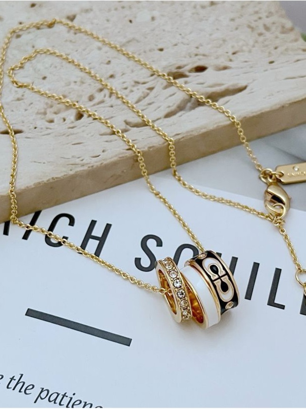 Coach Gold Necklace with White and Black Accent Rings
